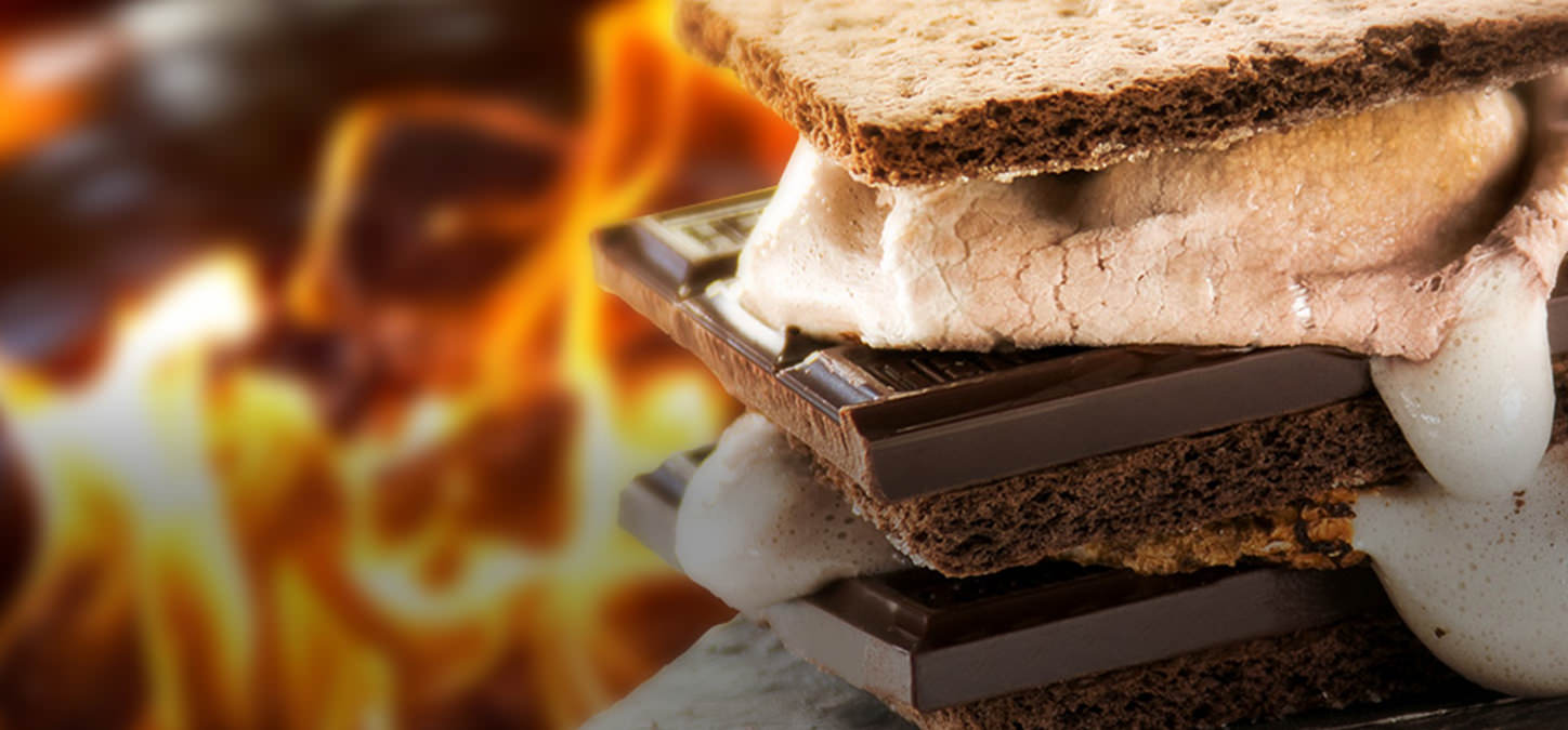 Roasted chocolate marshmallows, chocolate graham crackers & chocolate s'mores with flames in background