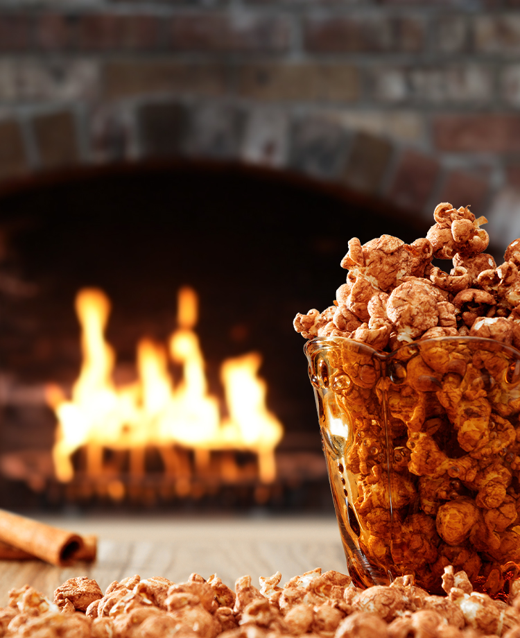 Bowl of flavored popcorn with duraflame firelog burning in the background