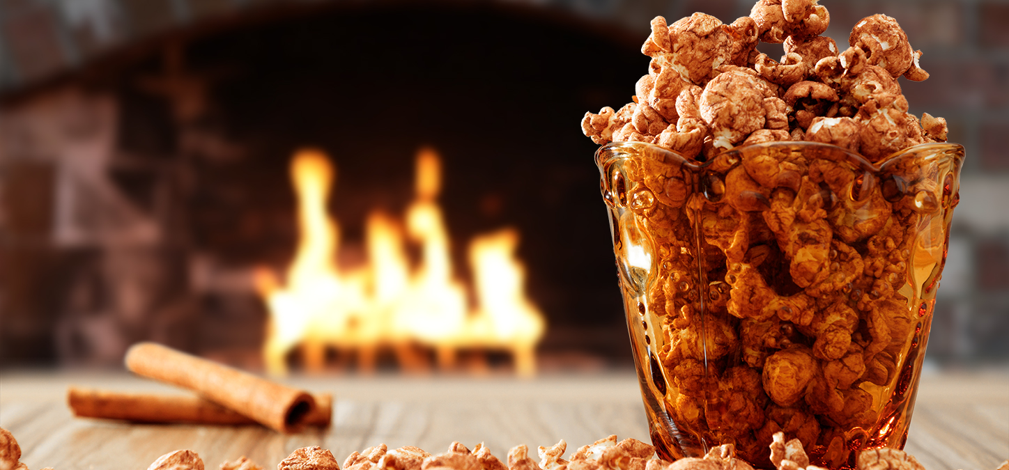 Bowl of flavored popcorn with duraflame firelog burning in the background