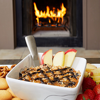 Cookie dip and fruit with a Duraflame fire burning in the background