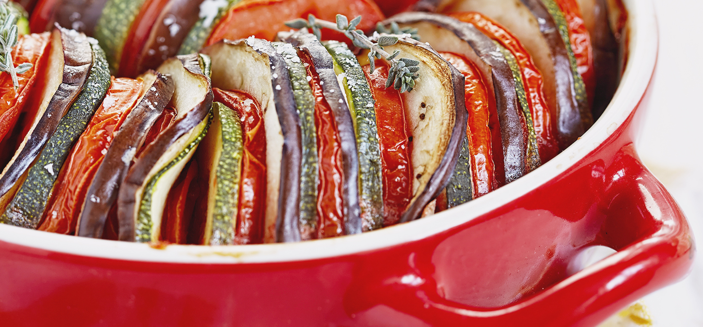 Ratatouille baked in a red casserole dish