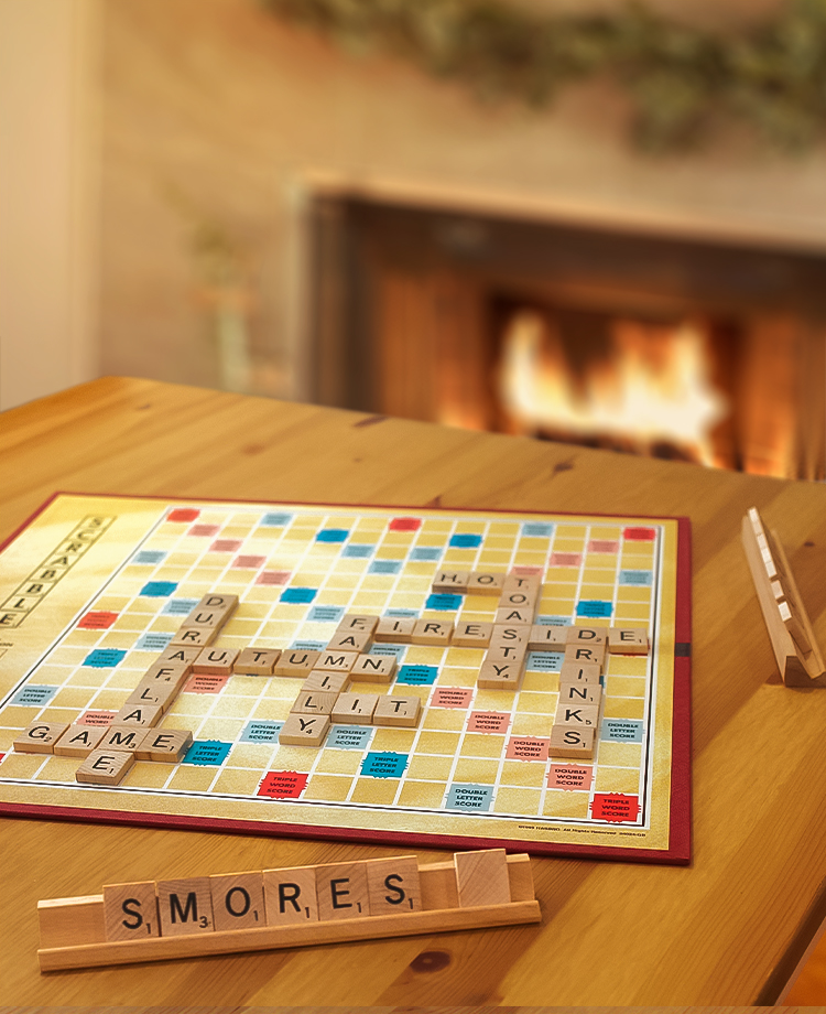 Scrabble board on table with Duraflame fire burning in hearth in the background