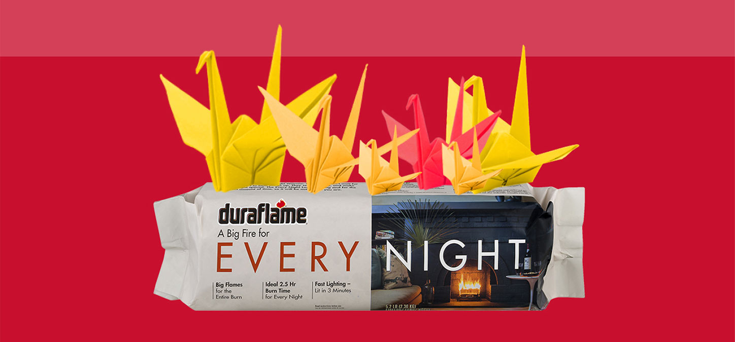 Duraflame Every Night firelog in packaging topped with oragami birds that look like flames