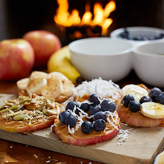 A variety of fruity snacks with a Duraflame fire burning in the background