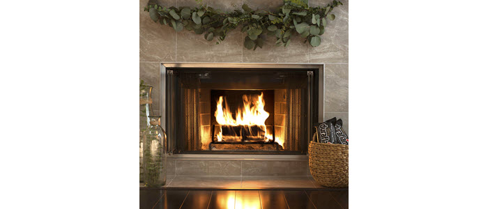 duraflame® 4.5lb Gold firelog burning in fireplace with garland and basket of firelogs