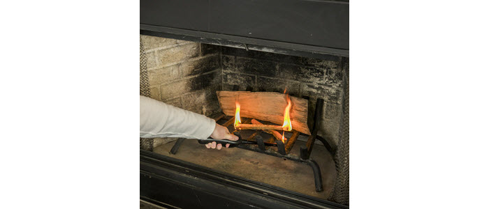 Lighter lighting duraflame® FATWOOD firestarters to start a wood fire in a fireplace