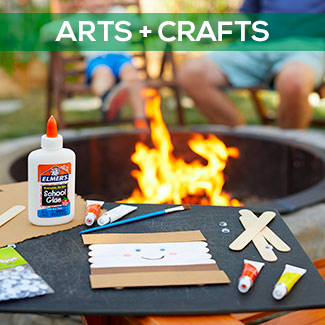 s'mores craft and art supplies with campfire in the background