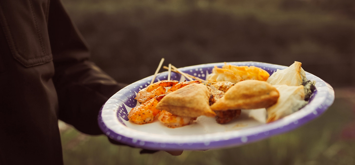 Plate with chicken empanadas, spanikopita and chili garlic shrimp skewers