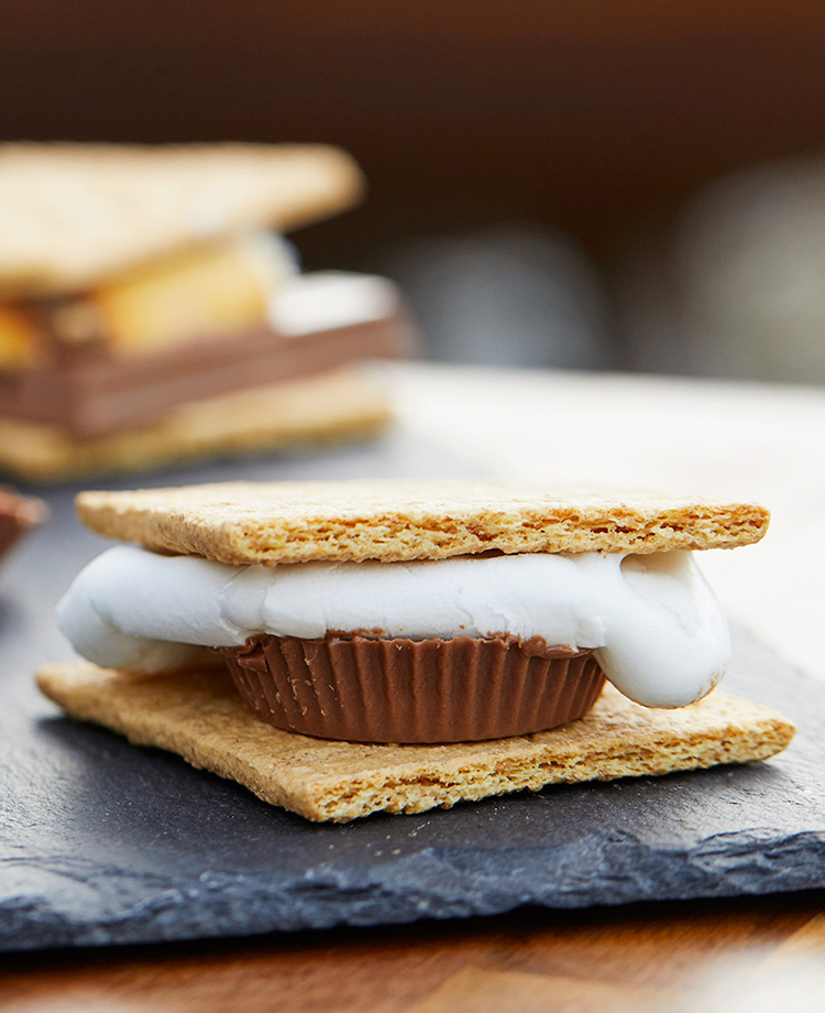 Smore's with chocolate peanut butter cup and marshmallows between graham crackers