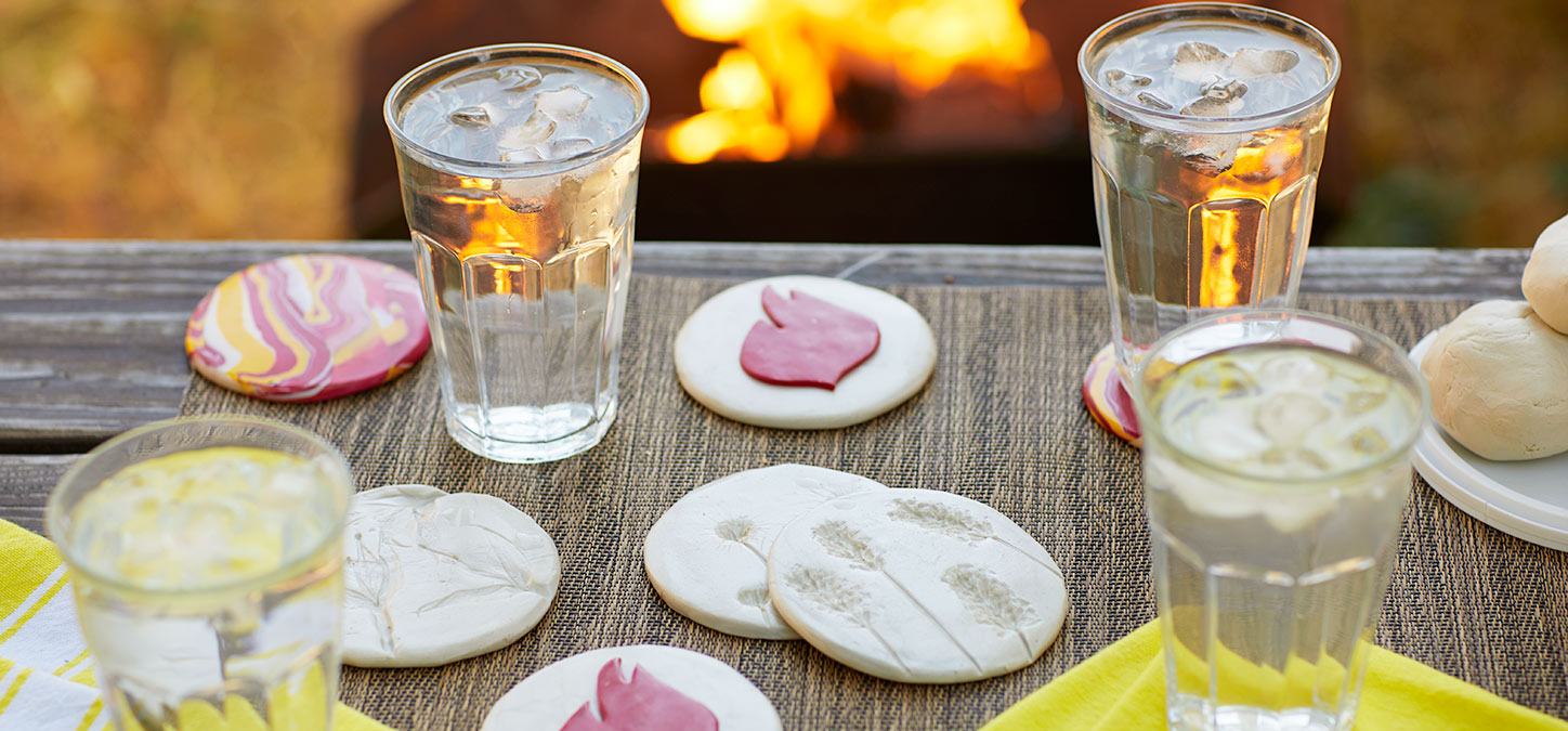 DIY clay coasters next to a fire pit