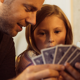 Father and Daughter playing cards