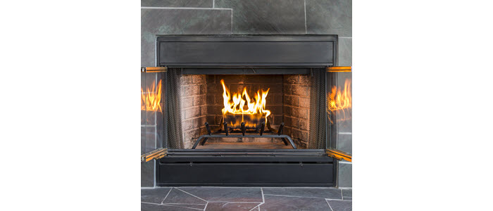 duraflame 2.5lb firelog burning with flames reflected on fireplace glass doors