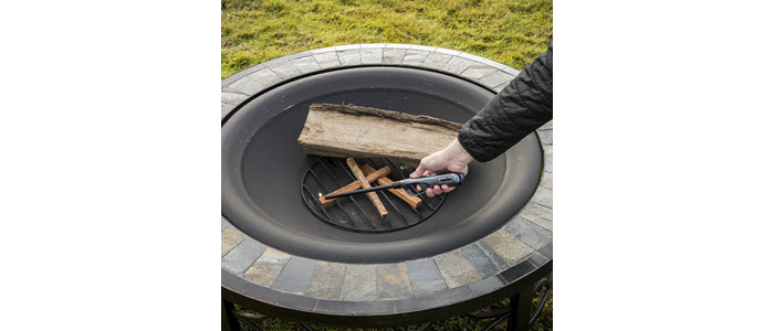 Lighter lighting duraflame® FATWOOD firestarters to start a wood fire in a firepit outdoors